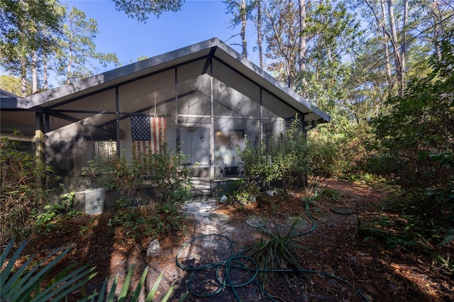 view of side of property featuring a sunroom