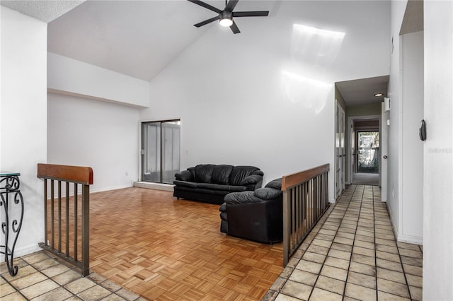 living room with high vaulted ceiling, baseboards, and a ceiling fan