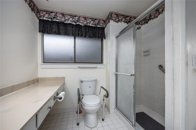 bathroom featuring baseboards, toilet, a shower stall, and tile patterned flooring