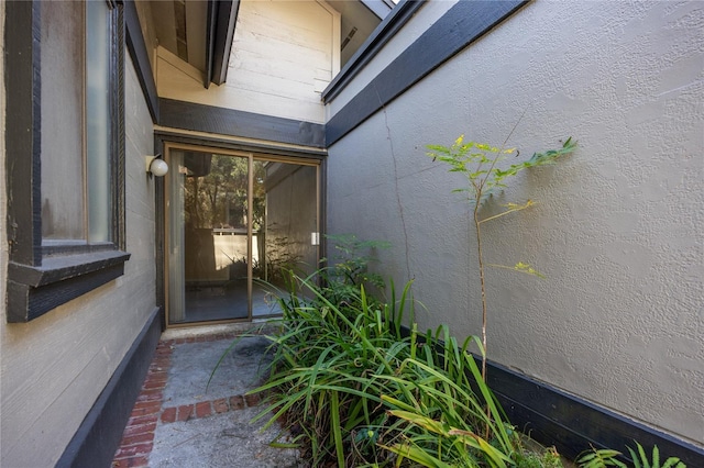 doorway to property with stucco siding