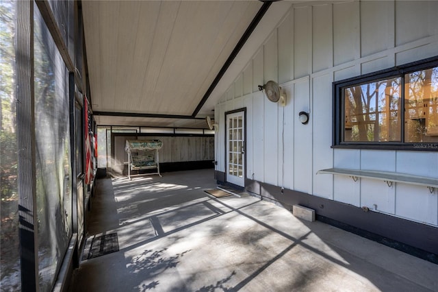 unfurnished sunroom featuring lofted ceiling