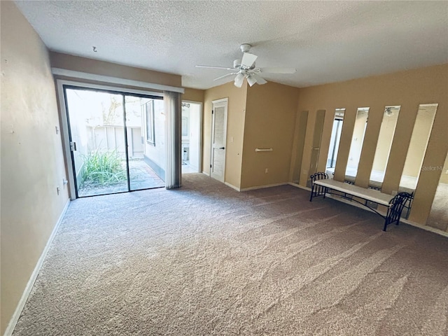 unfurnished room with a ceiling fan, baseboards, a textured ceiling, and carpet flooring