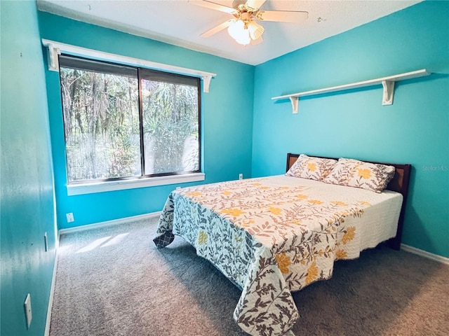 carpeted bedroom with baseboards and ceiling fan