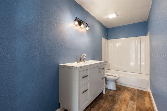 full bathroom featuring toilet, hardwood / wood-style flooring, vanity, and  shower combination