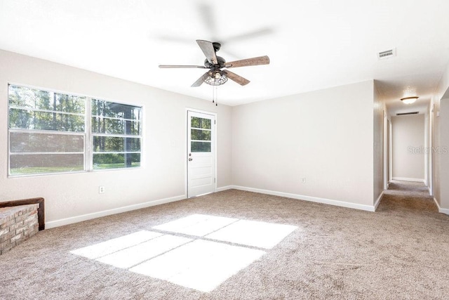 carpeted spare room with ceiling fan