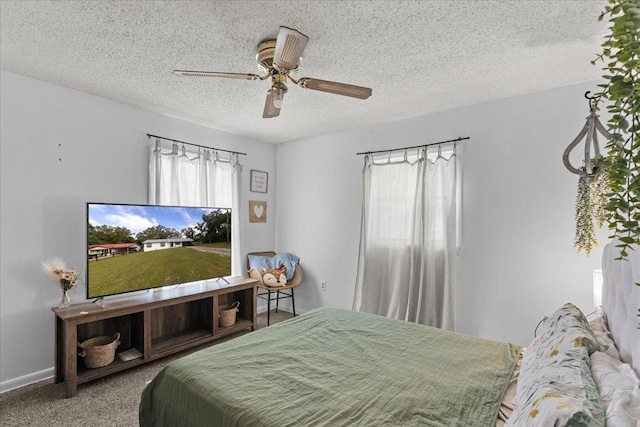 bedroom featuring ceiling fan, carpet, and a textured ceiling