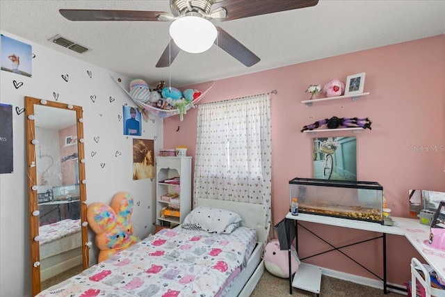 bedroom with a textured ceiling, ceiling fan, and carpet floors