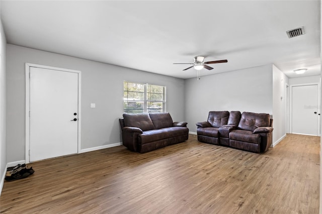 living room with ceiling fan and wood-type flooring