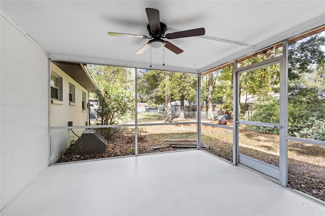 unfurnished sunroom featuring a wealth of natural light and ceiling fan