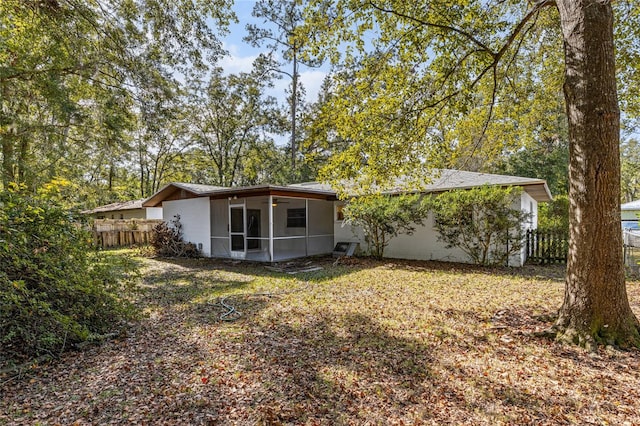 rear view of house featuring a sunroom