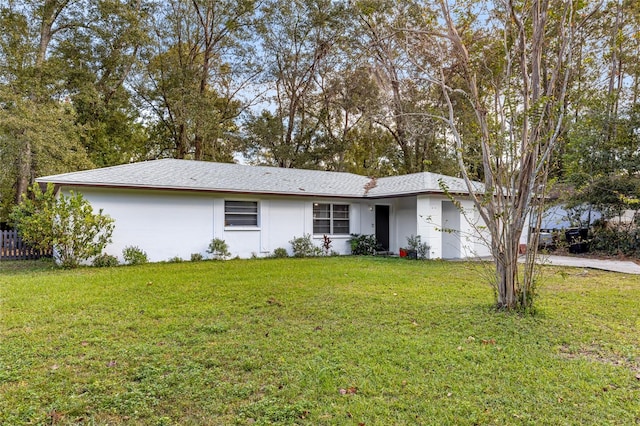 ranch-style home with a garage and a front lawn