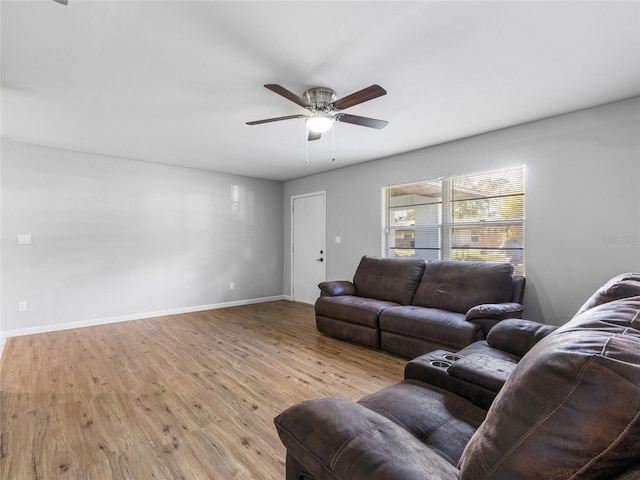 living room with light hardwood / wood-style flooring and ceiling fan