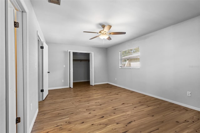 unfurnished bedroom featuring hardwood / wood-style floors and ceiling fan