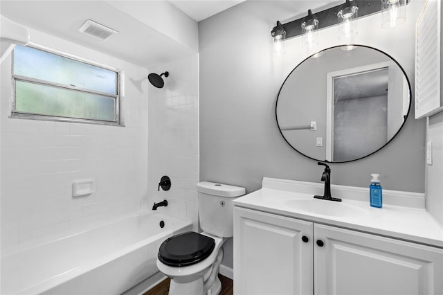 full bathroom featuring toilet, tiled shower / bath combo, vanity, and hardwood / wood-style flooring