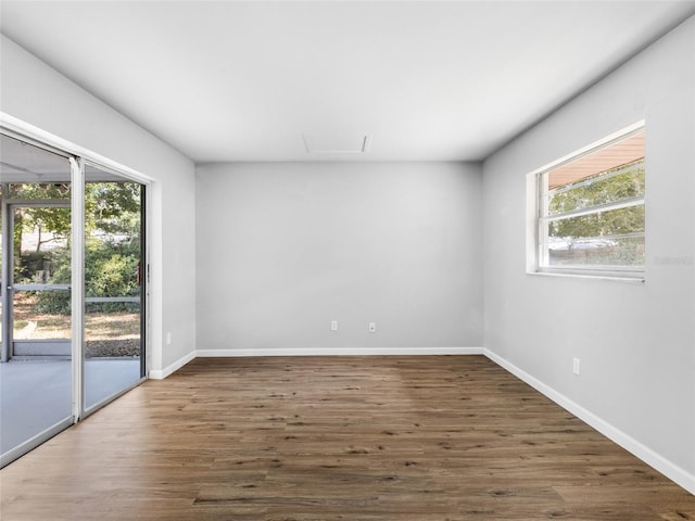 spare room with dark hardwood / wood-style floors