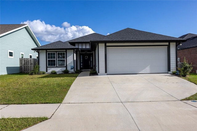 view of front of property with a front yard and a garage