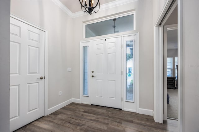 entryway featuring ornamental molding, dark hardwood / wood-style floors, and a chandelier