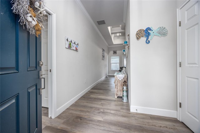 entrance foyer with crown molding and wood-type flooring