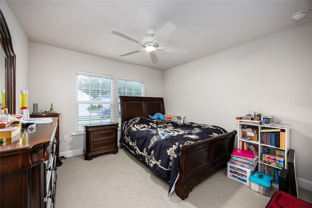 bedroom with light colored carpet and ceiling fan