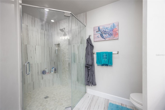 bathroom featuring toilet and an enclosed shower