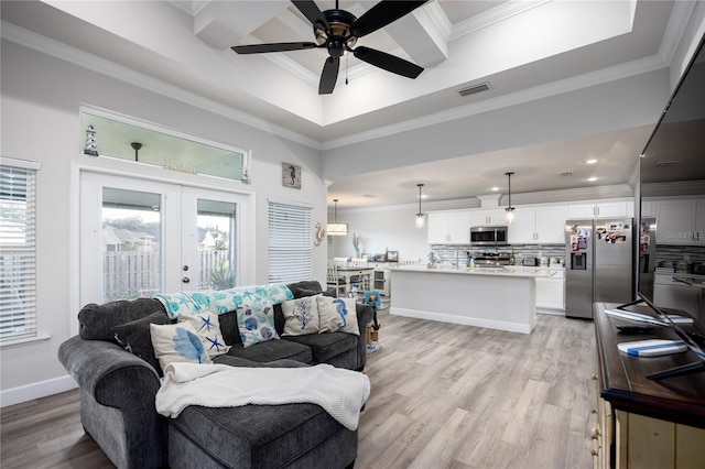 living room featuring crown molding, french doors, light wood-type flooring, and ceiling fan