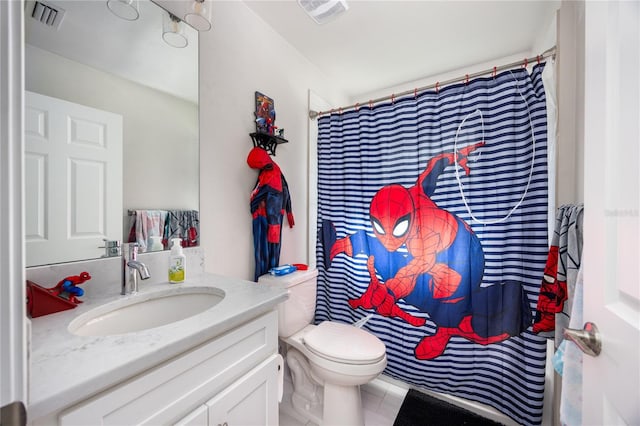 bathroom with vanity, walk in shower, toilet, and tile patterned flooring