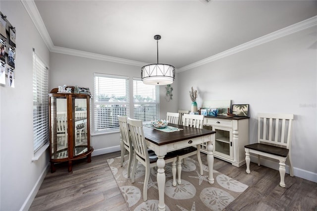 dining space featuring crown molding and dark wood-type flooring