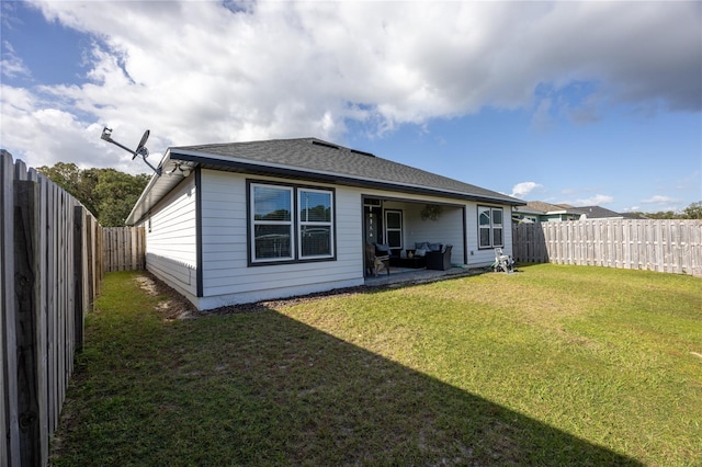 back of property featuring a patio and a lawn