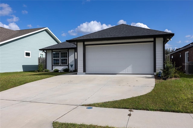 ranch-style house with a front yard and a garage