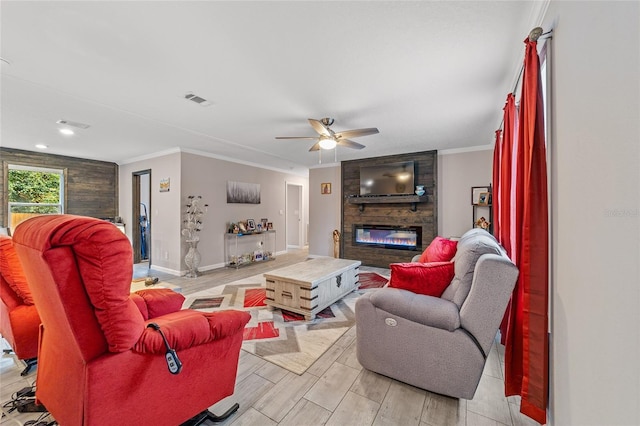 living room featuring a fireplace, light wood-type flooring, ceiling fan, and crown molding