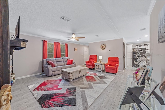 living room with ornamental molding, ceiling fan, light hardwood / wood-style floors, and a textured ceiling