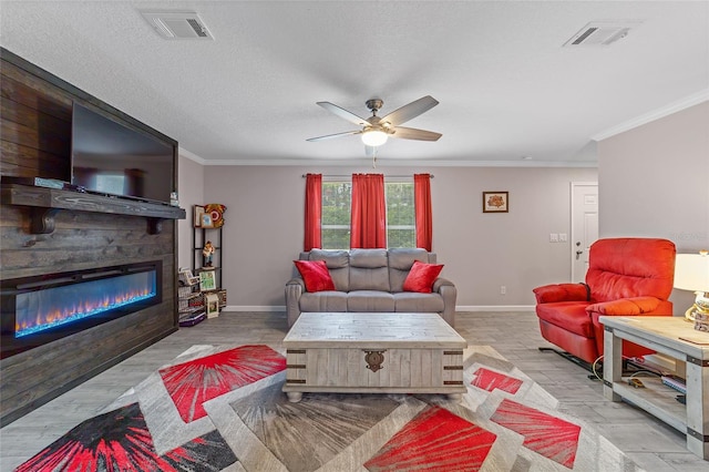 living room featuring ceiling fan, crown molding, light hardwood / wood-style floors, and a textured ceiling