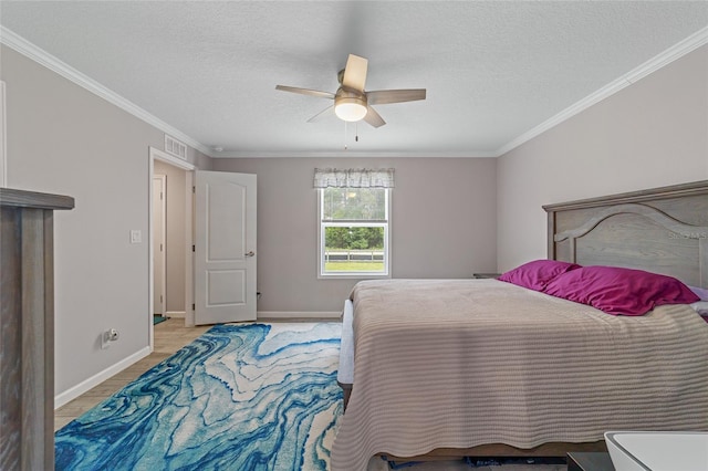 bedroom featuring a textured ceiling, ceiling fan, and ornamental molding