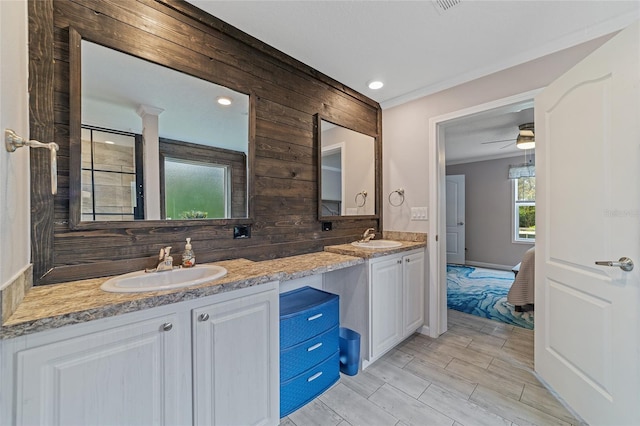 bathroom with wood walls, vanity, hardwood / wood-style flooring, and ceiling fan