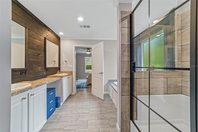 bathroom with vanity, wooden walls, separate shower and tub, and ceiling fan