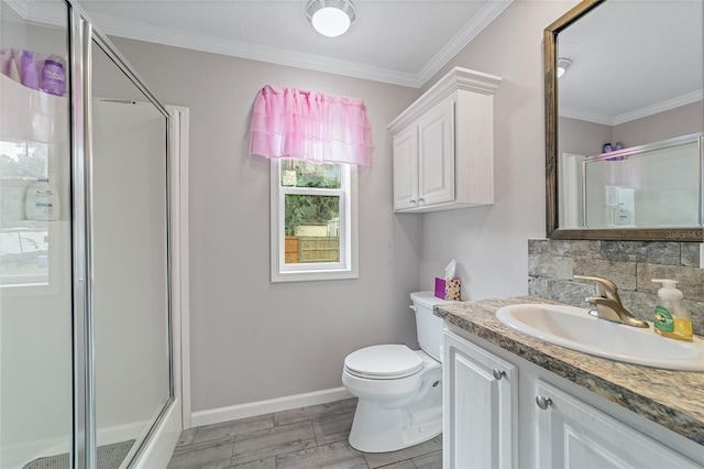 bathroom with vanity, toilet, walk in shower, and crown molding