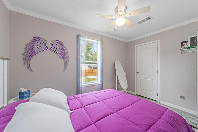 bedroom with a textured ceiling, ceiling fan, and ornamental molding