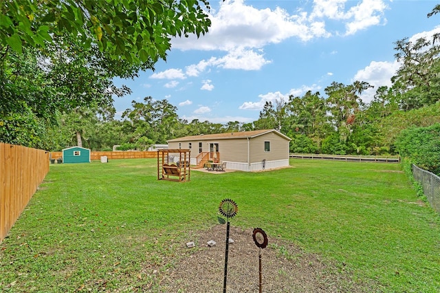 view of yard with a shed and a wooden deck