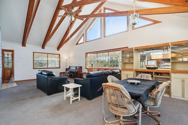 carpeted dining area with beam ceiling, high vaulted ceiling, and ceiling fan