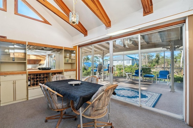 dining space with beam ceiling, high vaulted ceiling, and carpet flooring