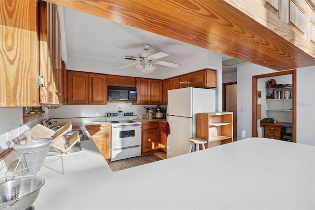 kitchen featuring sink, kitchen peninsula, white appliances, and ceiling fan