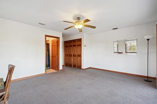 spare room featuring ceiling fan and carpet floors