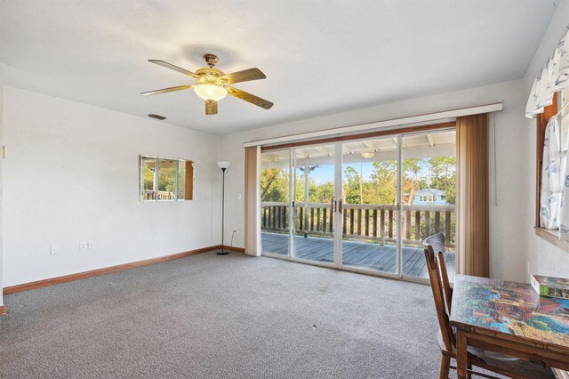 interior space featuring ceiling fan and carpet flooring