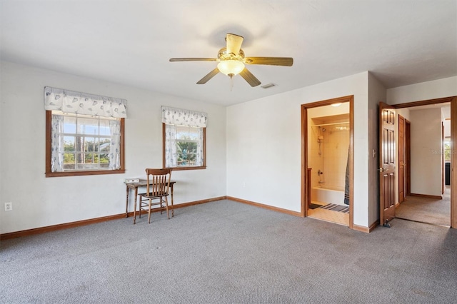 carpeted spare room with ceiling fan