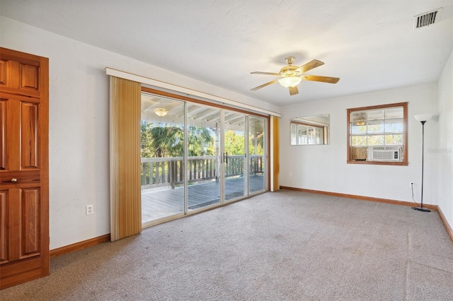 spare room with cooling unit, carpet, and ceiling fan