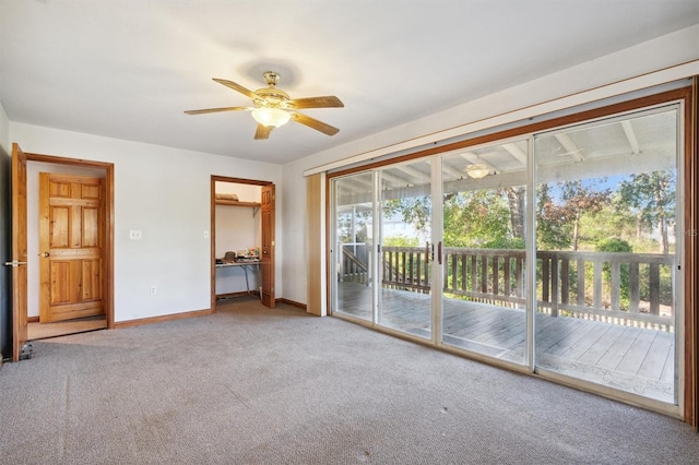 interior space with carpet floors and ceiling fan