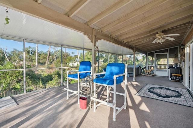 unfurnished sunroom with lofted ceiling and ceiling fan