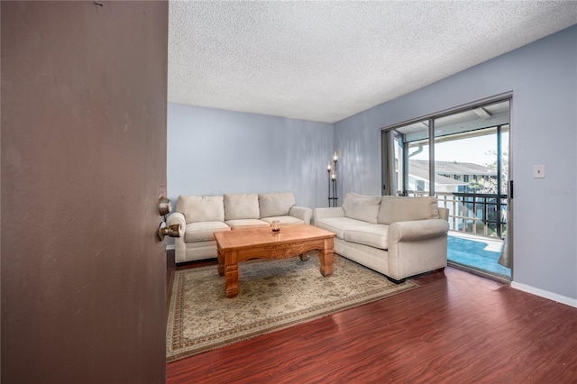 living room with a textured ceiling and hardwood / wood-style flooring