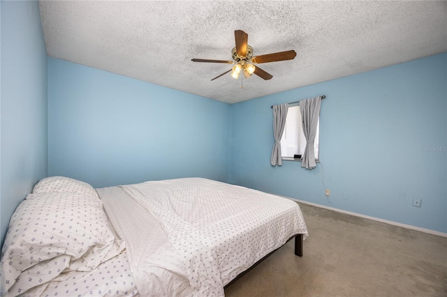 carpeted bedroom with a textured ceiling and ceiling fan