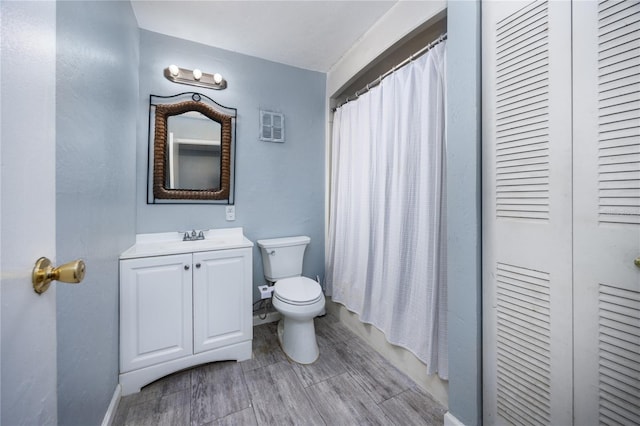 bathroom featuring vanity, toilet, and walk in shower